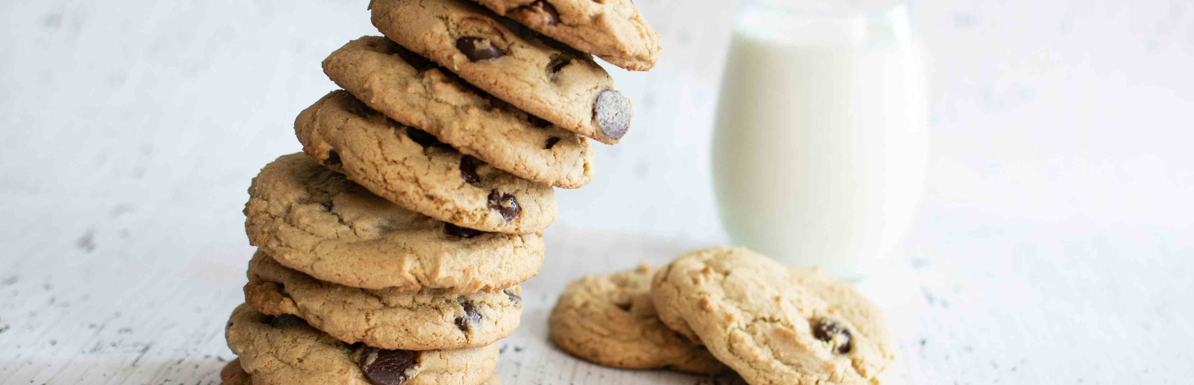 Stack of cookies next to a glass of milk