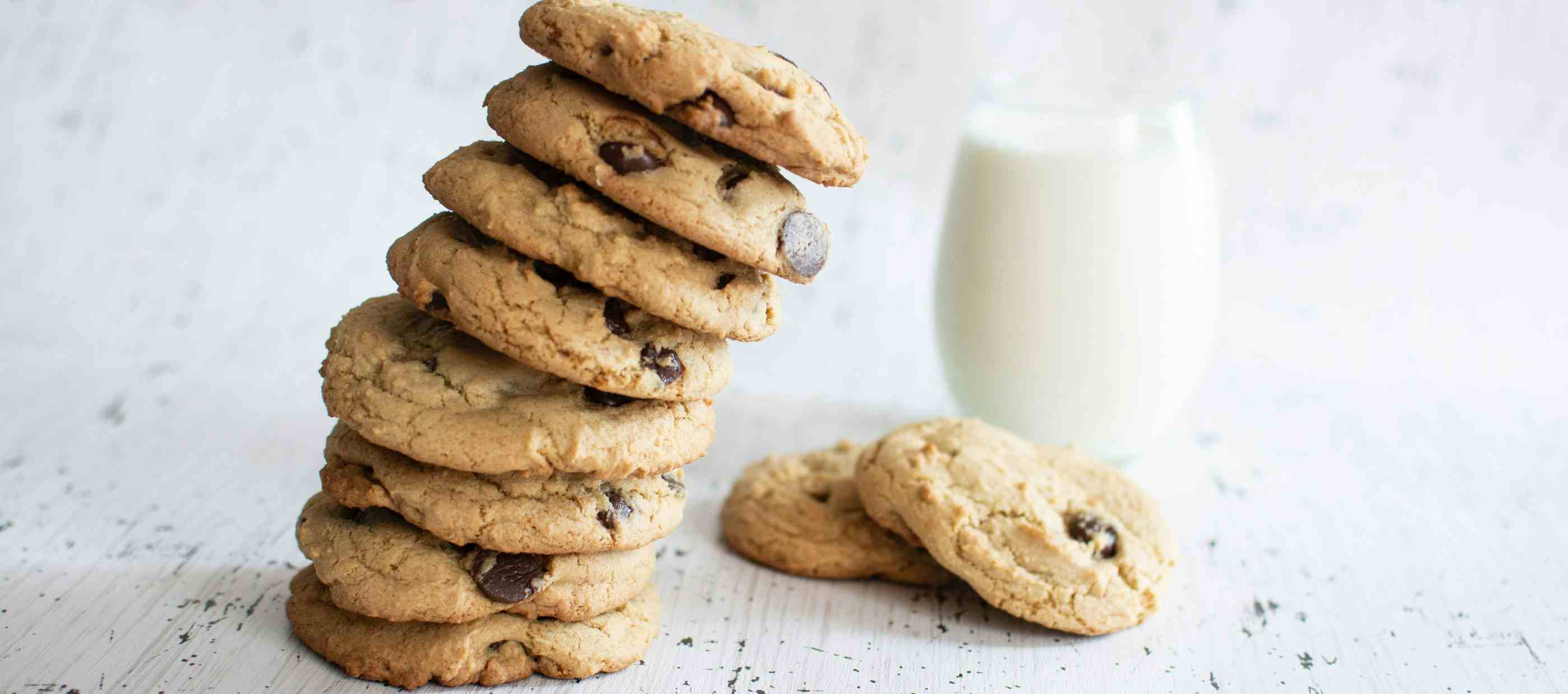 Stack of cookies next to a glass of milk