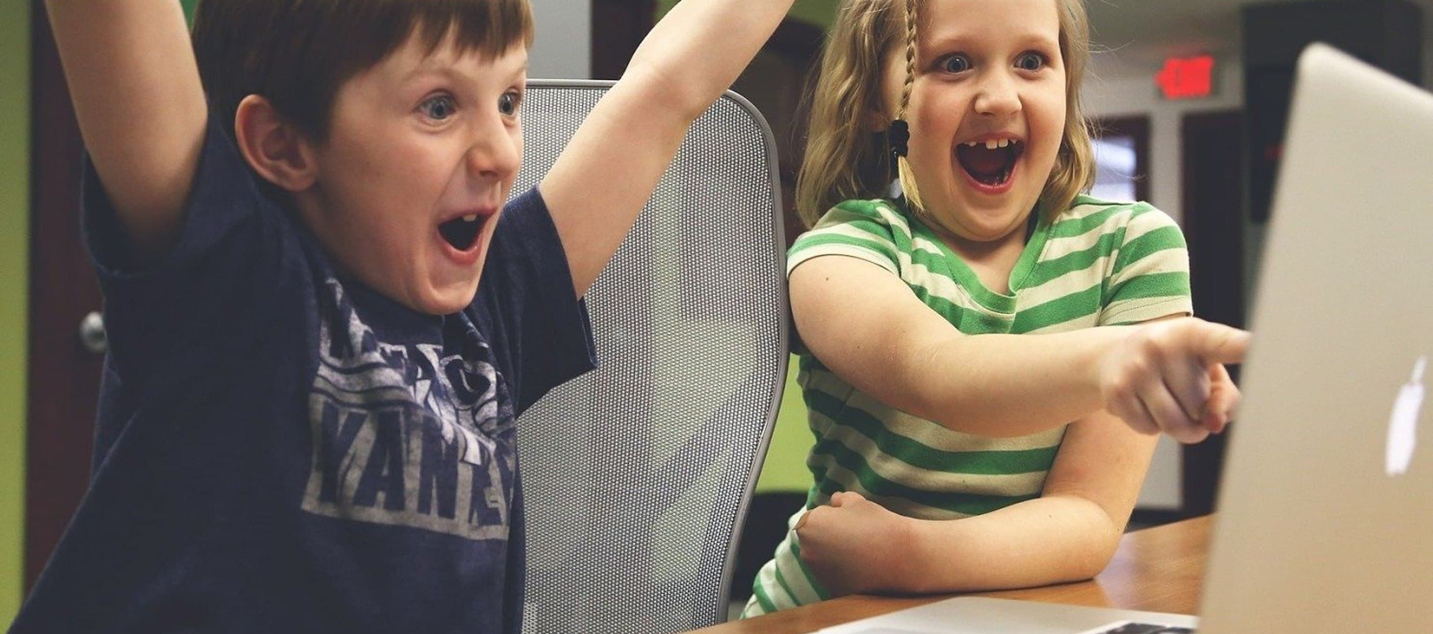 Children happy startup at laptop