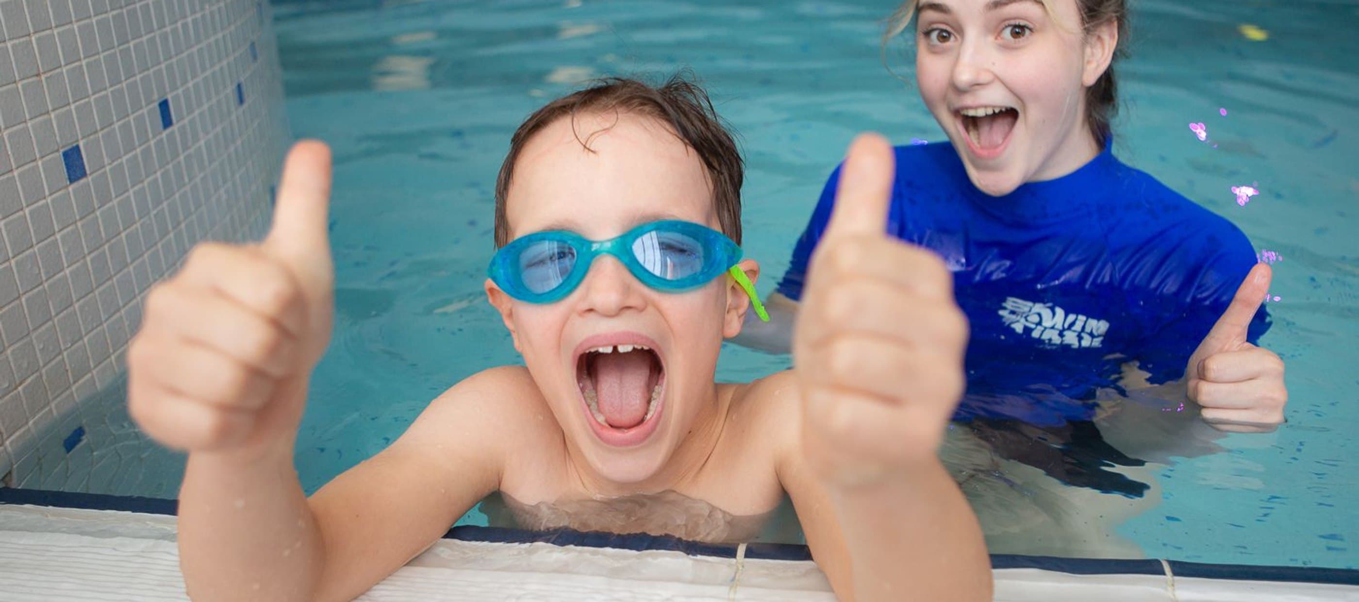 Swimming instructor and child floaty fun