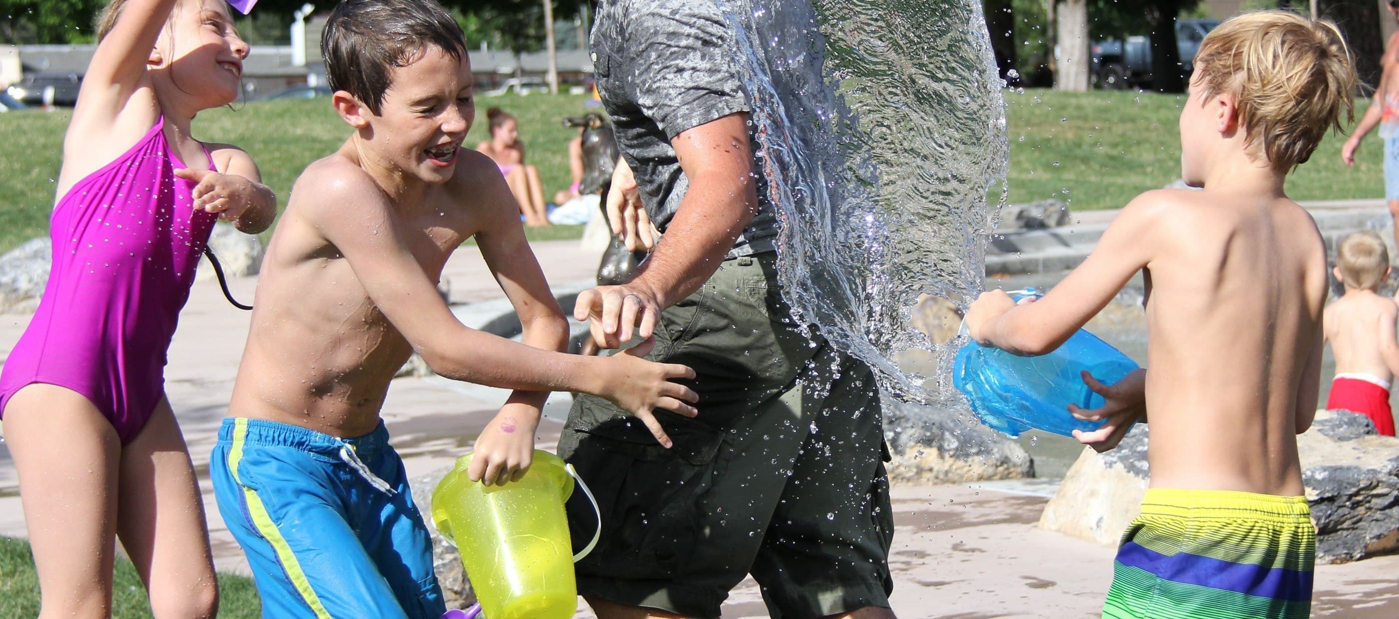 Children chucking buckets of water