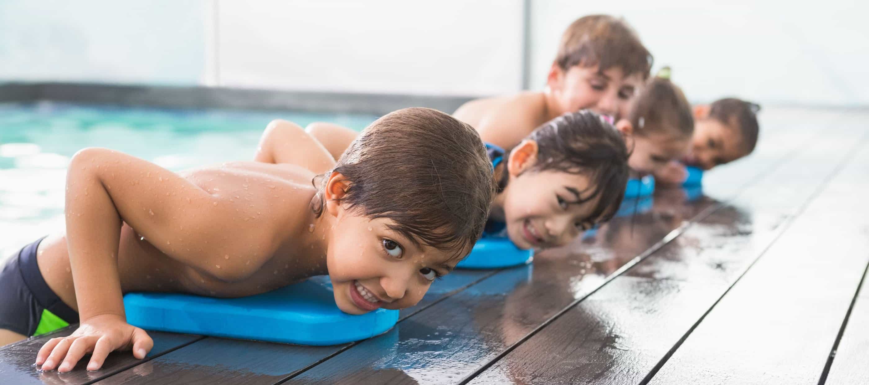 Child resting on side of pool