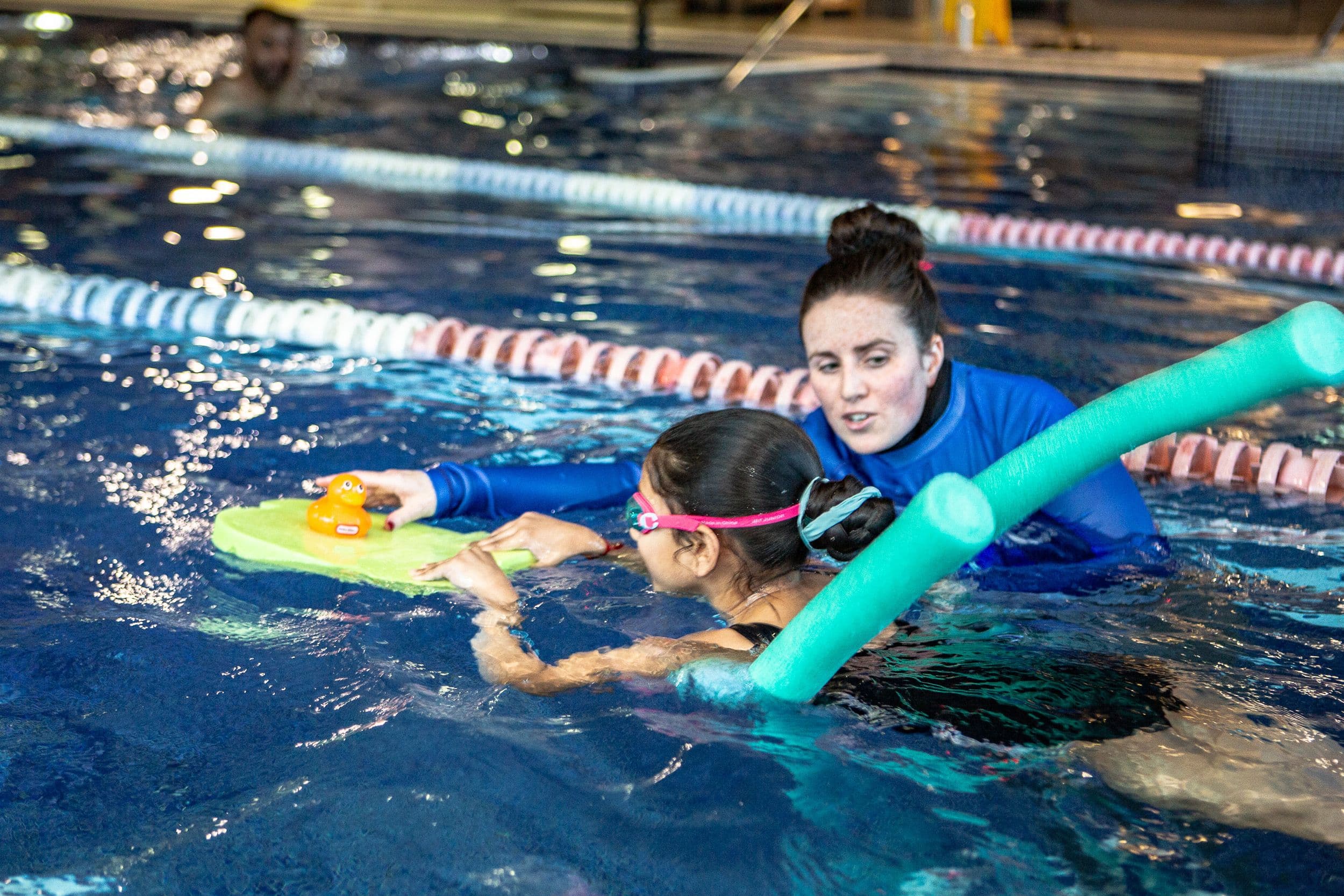 Child swimming with floaties
